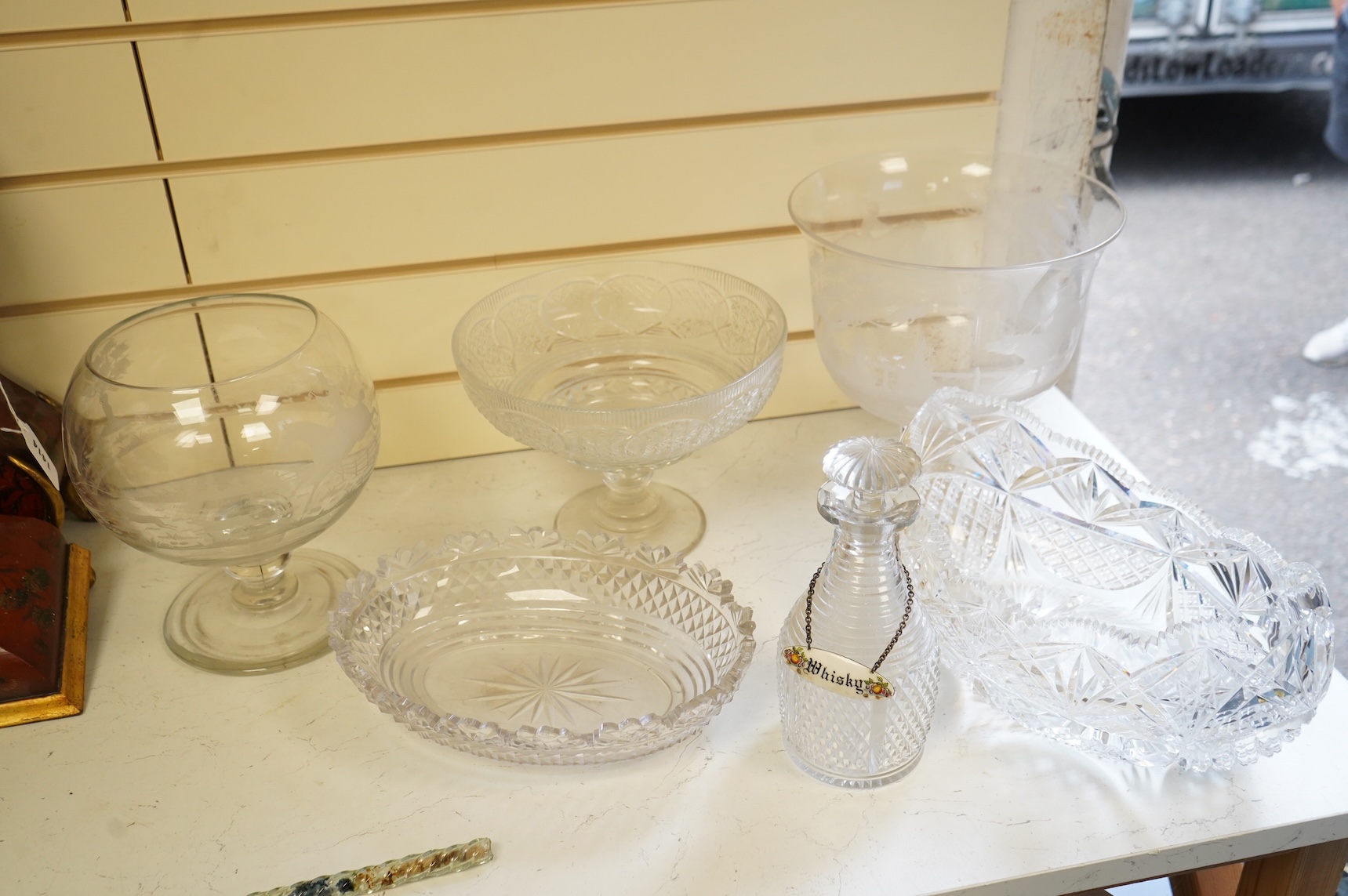 Two footed glass bowls engraved with racing and hunting scenes, an early 19th century oval cut glass fruit bowl, another, modern, together with a small Regency mallet shaped decanter, with an enamel label ‘’Whisky’’, (6)